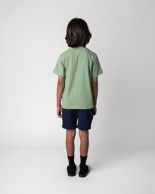 Kid wearing the Badges Short in ink with the Chill Sloth Tee in lime stripe, back view