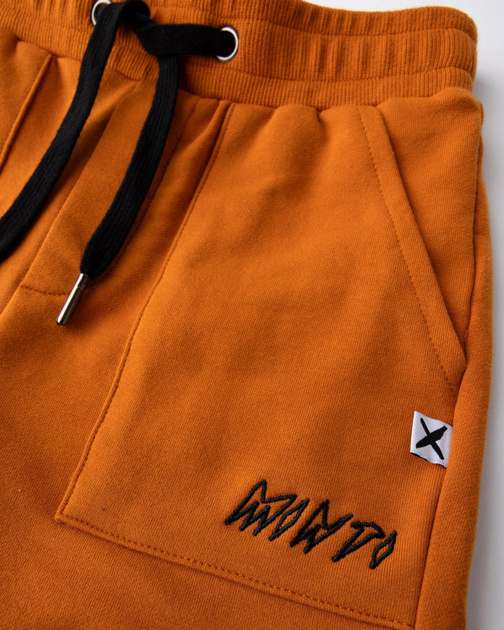 Close up detail of the Track Short in burnt orange