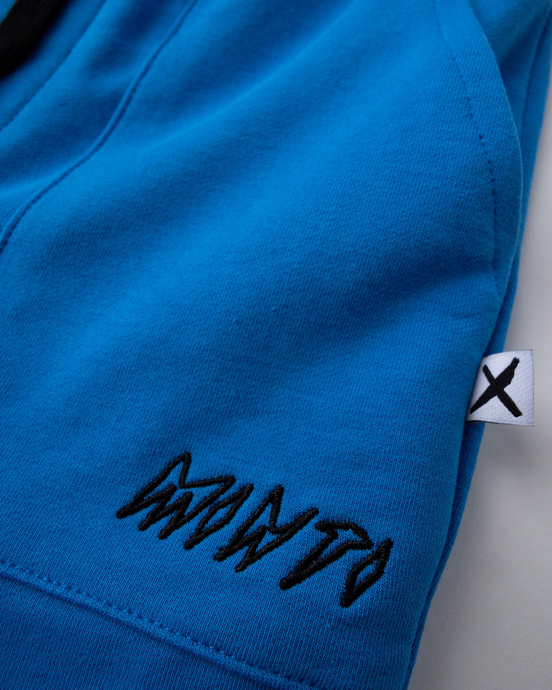 Close up detail of the Track Short in cobalt