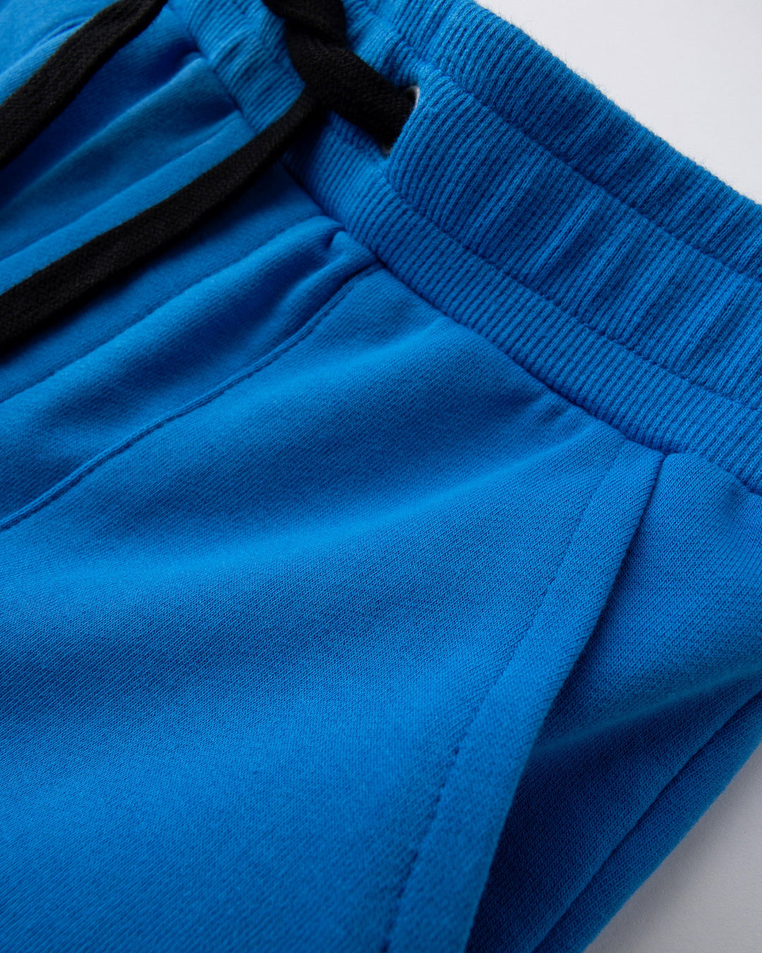 Close up detail of the Track Short in cobalt