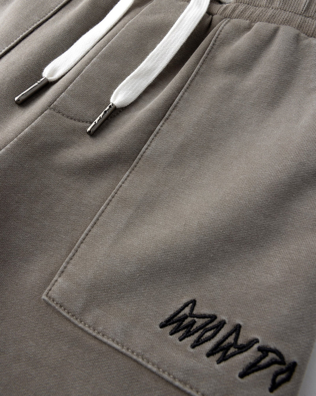 Close up detail of the Blasted Track Short in grey wash