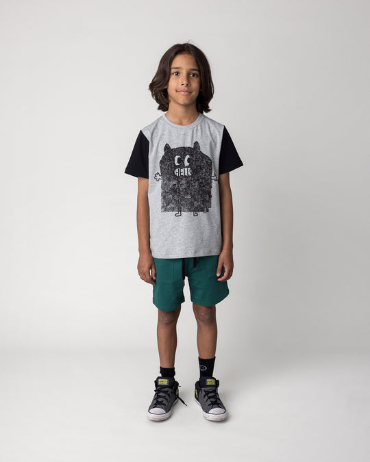 Kid wearing the Track Short in kelly green with the Patchwork Monster Tee in grey marle and black, front view