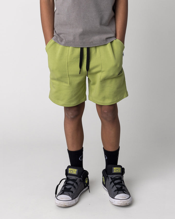 Kid wearing the Track Short in lime, front view close up