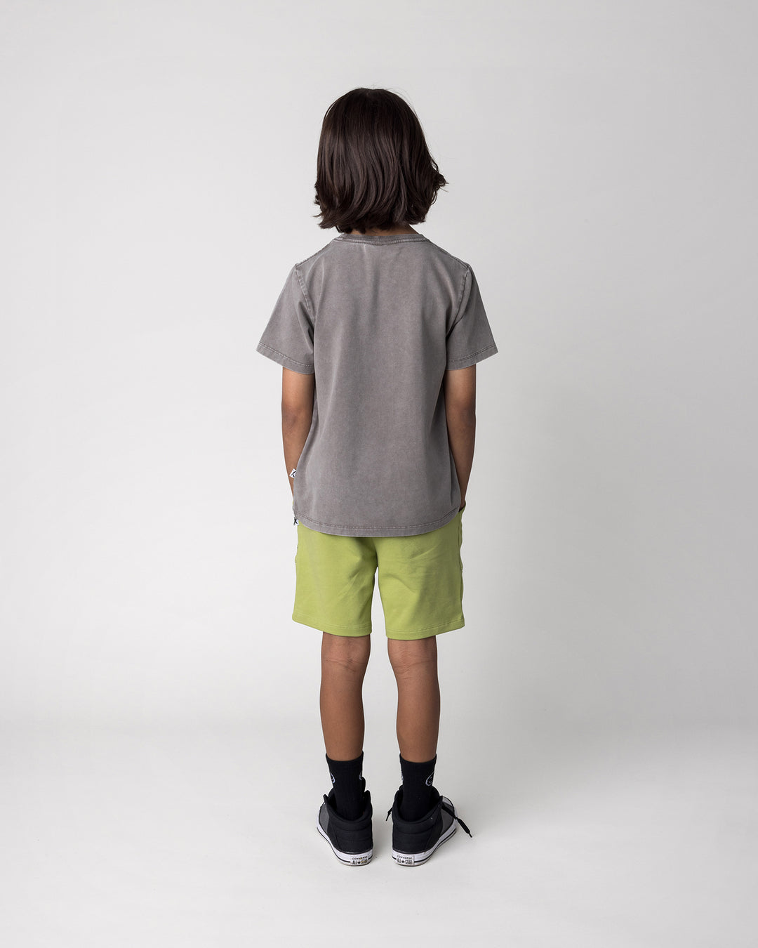 Kid wearing the Track Short in lime with the Cool Crew Tee in grey wash, back view