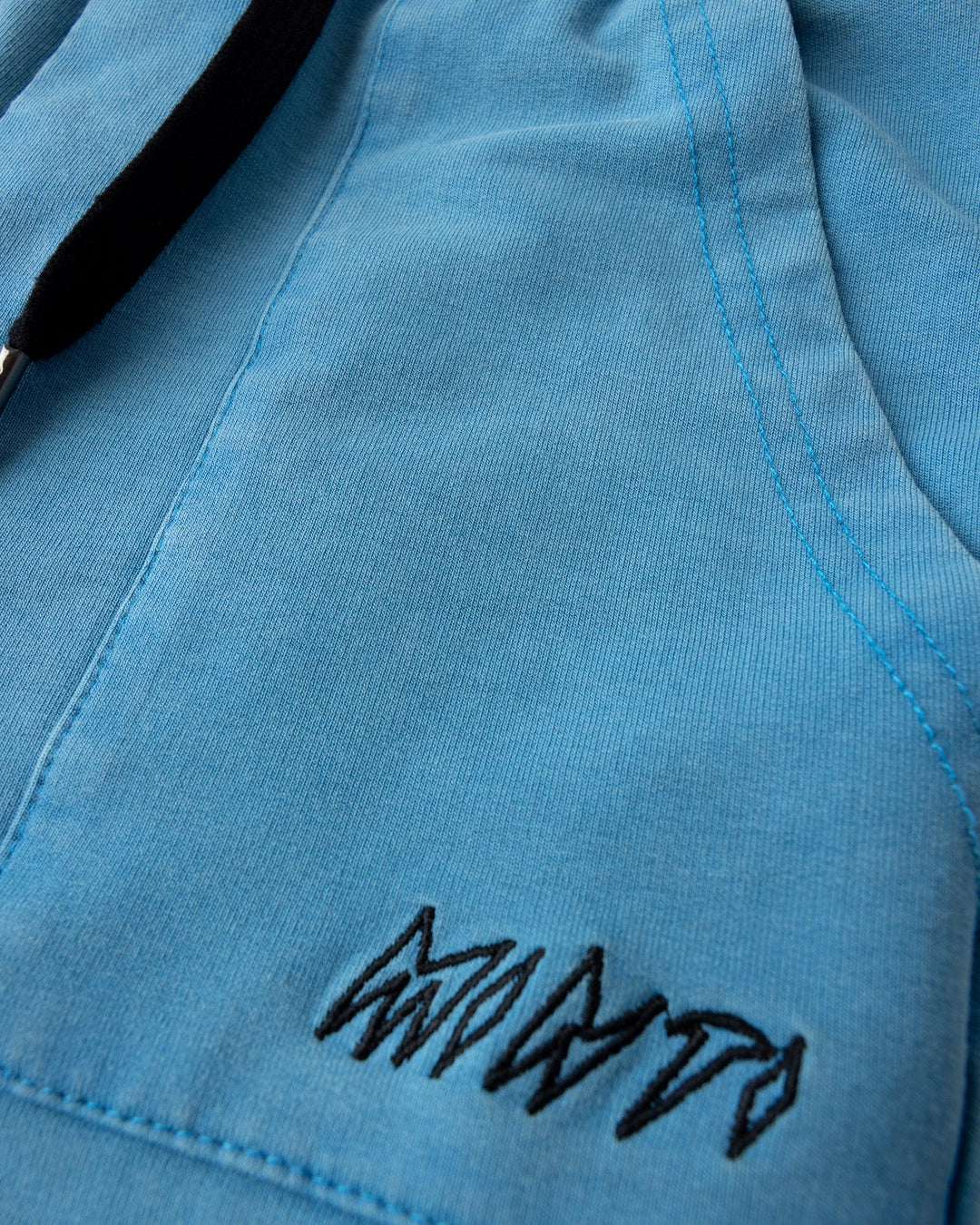 Close up detail of the Blasted Track Short in sky wash