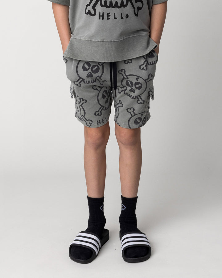 Kid wearing the Hello Skull Short in grey wash, front view close up