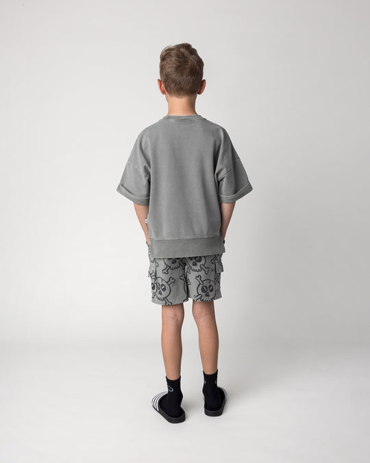 Kid wearing the Hello Skull Short in grey wash with the Hello Skull Short Sleeve Crew in grey wash, back view