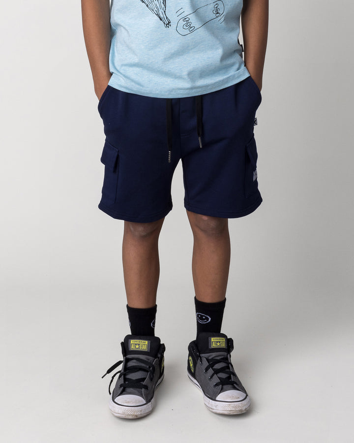 Kid wearing the Deluxe Cargo Short in ink, front view close up