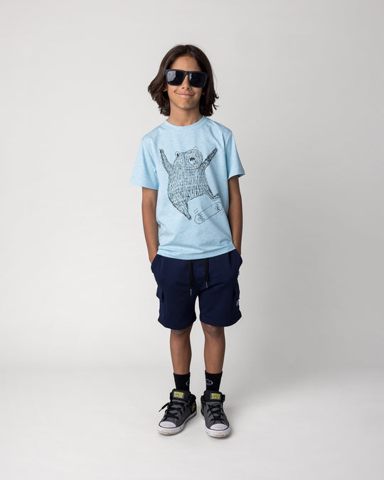 Kid wearing the Deluxe Cargo Short in ink with the Boarding Bear Tee in blue marle, front view