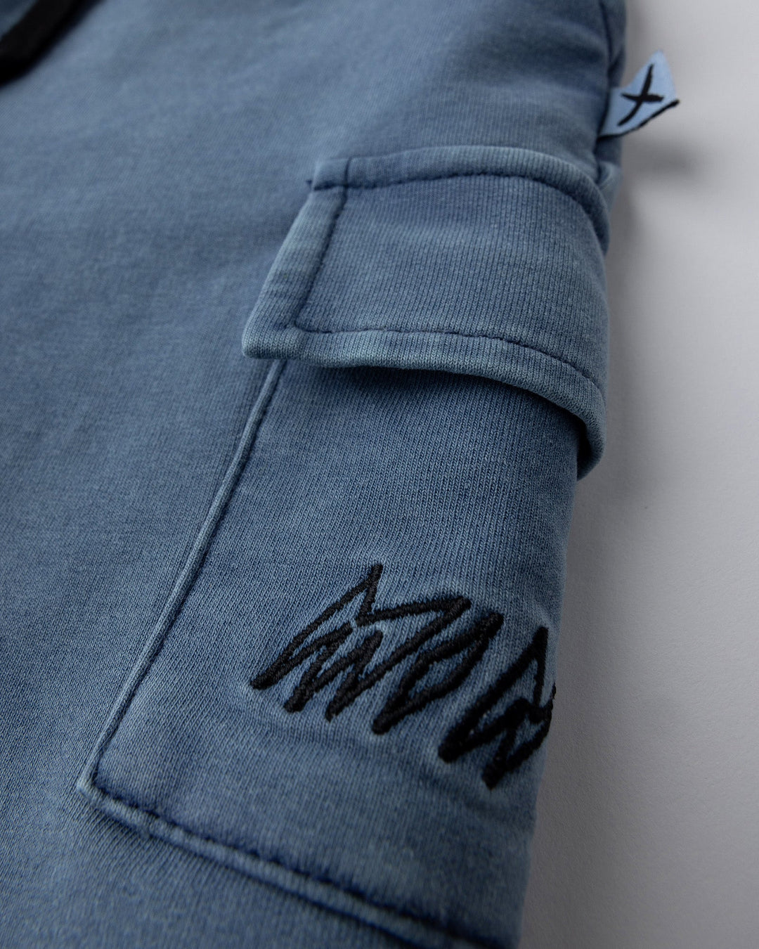Close up detail of the Blasted Deluxe Cargo Short in midnight wash