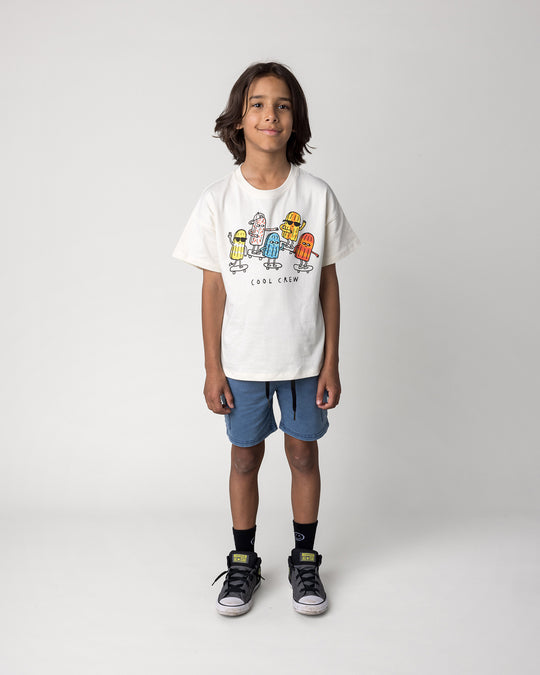 Kid wearing the Blasted Deluxe Cargo Short in midnight wash with the Cool Crew Tee in cream, front view