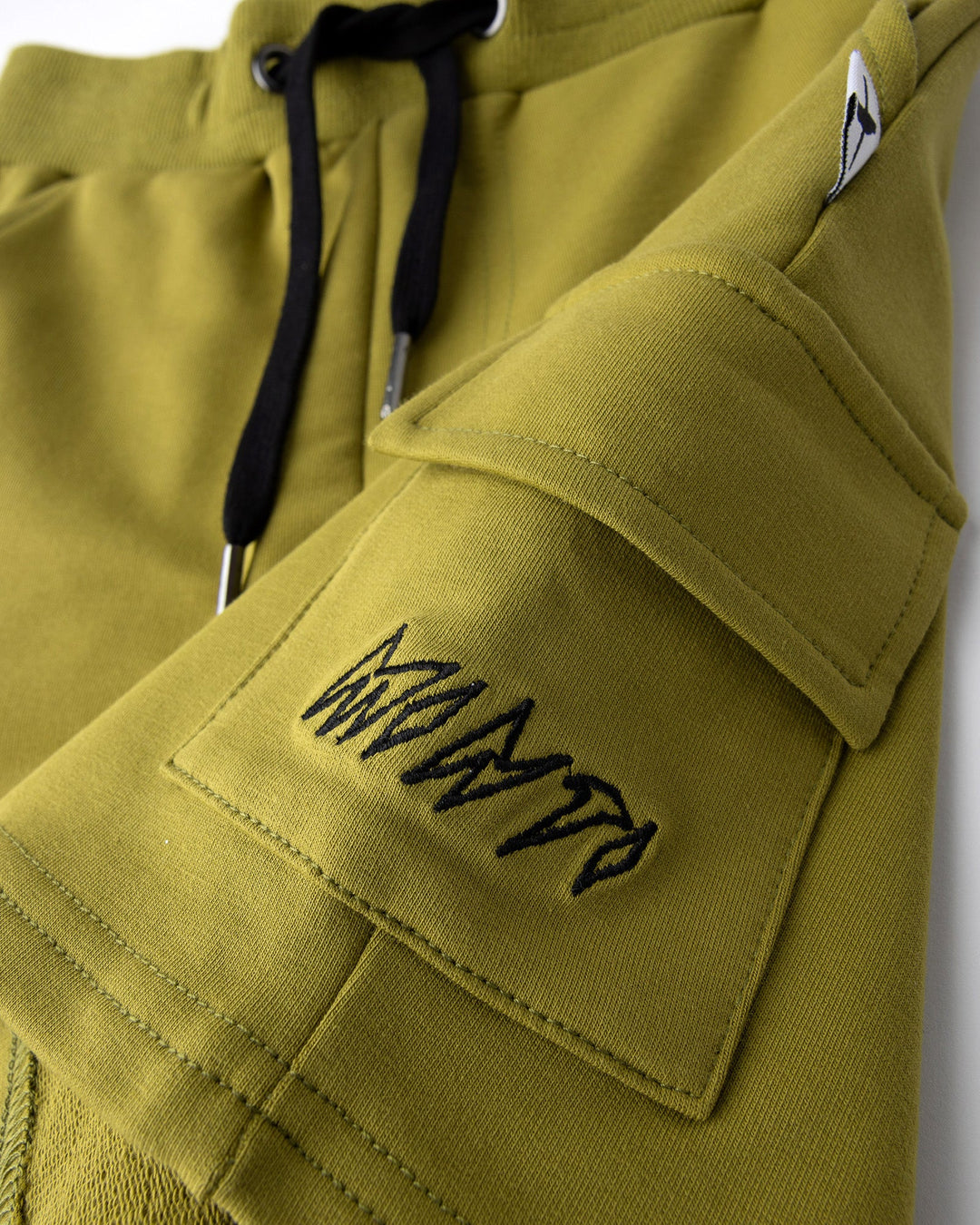 Close up detail of the Deluxe Cargo Short in olive