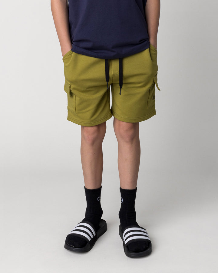 Kid wearing the Deluxe Cargo Short in olive, front view close up