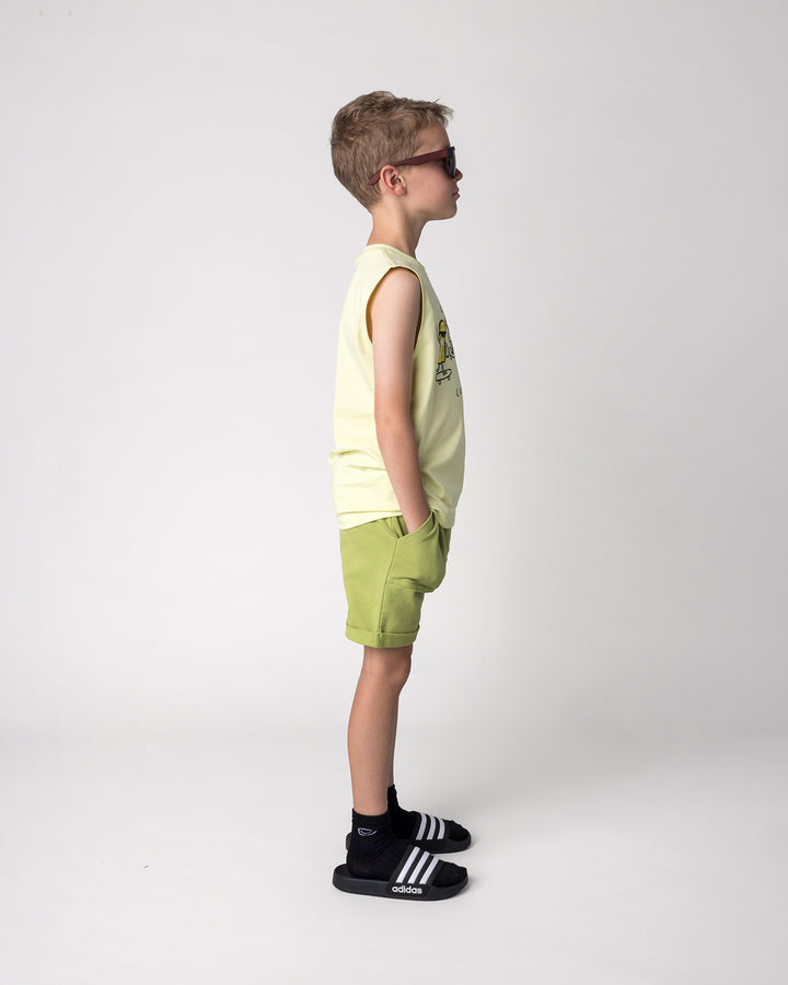 Kid wearing the Roller Short in lime with the Cool Crew Sleeveless Tee in light zest, side view