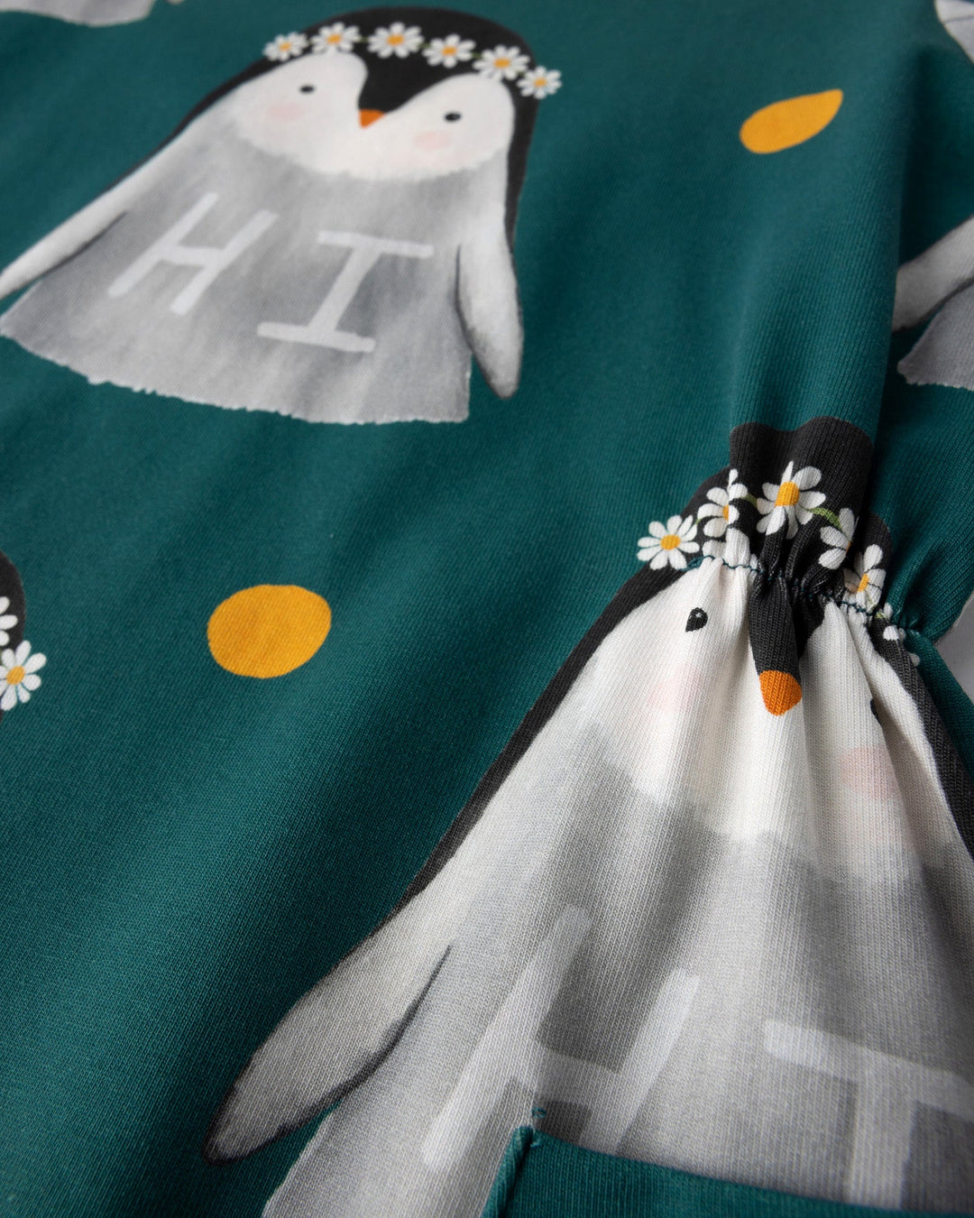 Close up of the Flower Penguin Dress print in dark green