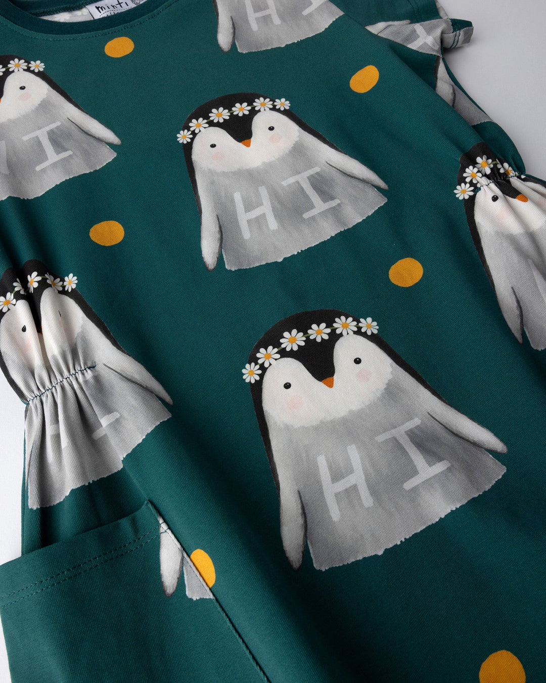 Close up of the Flower Penguin Dress print in dark green
