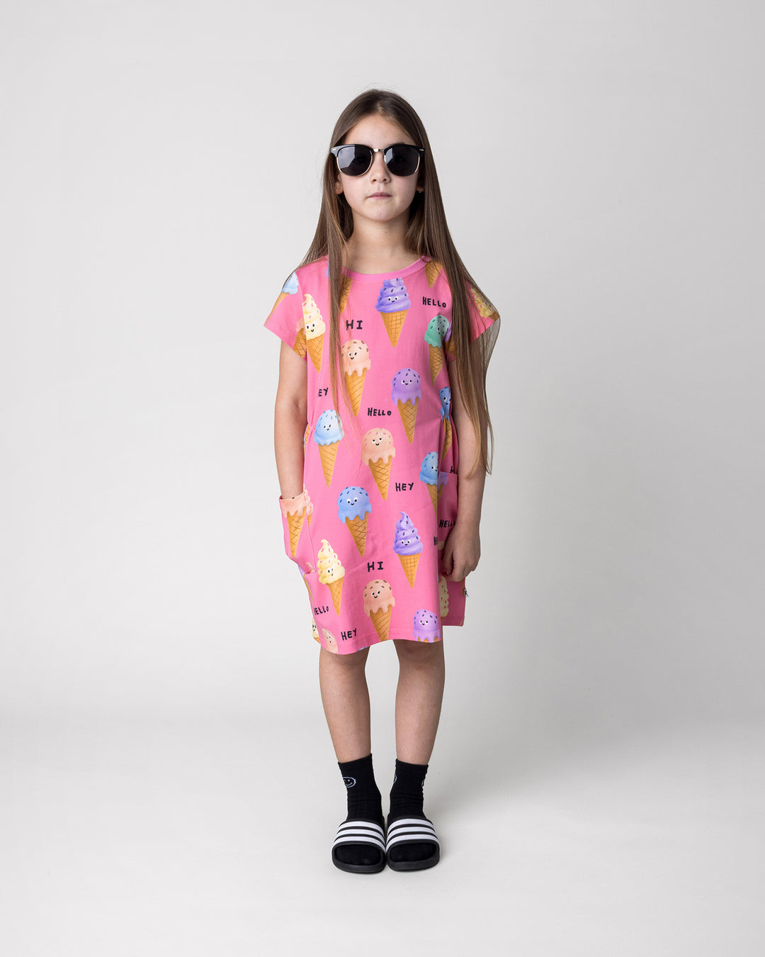 Kid wearing the Happy Icecreams Dress in pink, front view