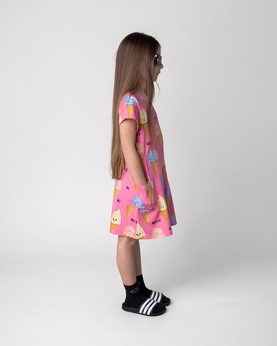 Kid wearing the Happy Icecreams Dress in pink, side view