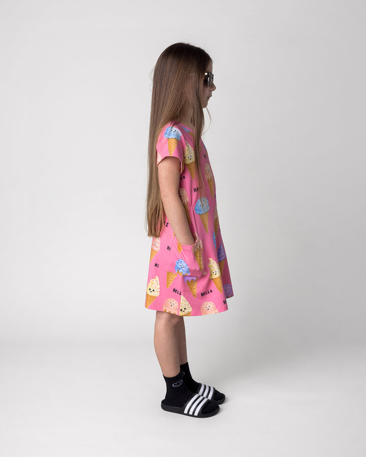 Kid wearing the Happy Icecreams Dress in pink, side view