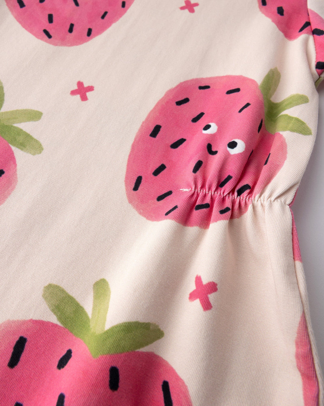 Close up of the Happy Strawberry Dress print in cream