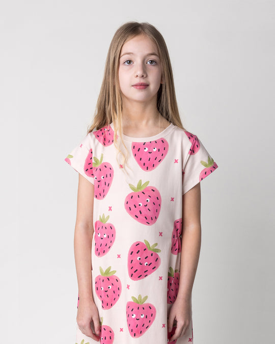Close up of the Happy Strawberry Dress in cream on a kid, front view