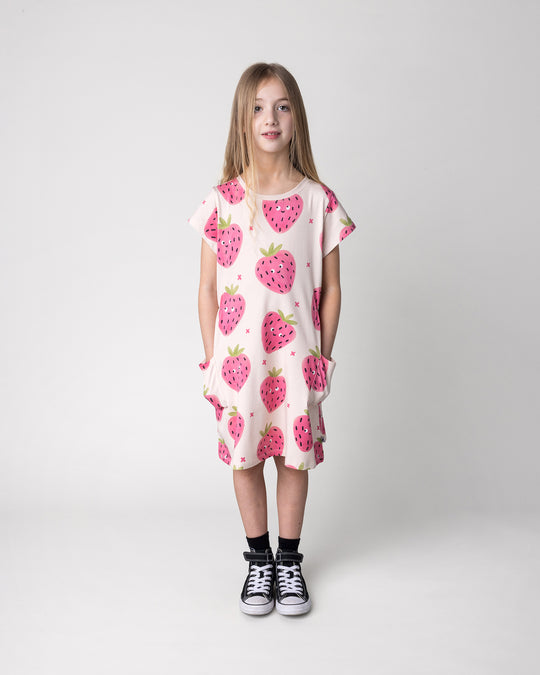 Kid wearing the Happy Strawberry Dress in cream, front view