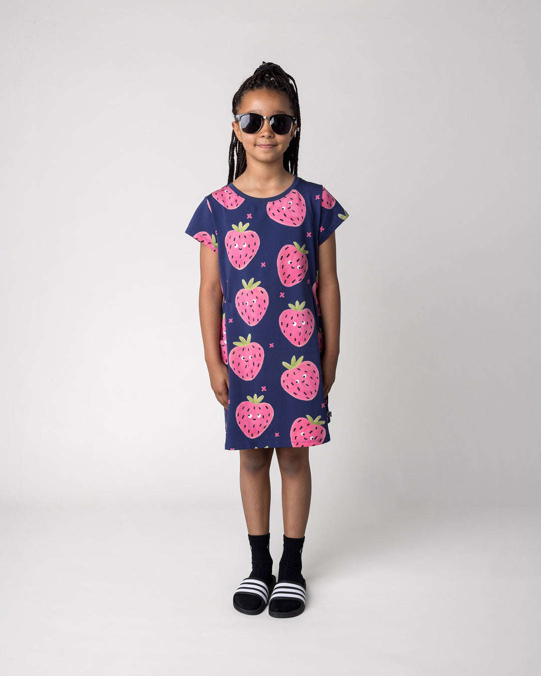 Kid wearing the Happy Strawberry Dress in turquoise, front view