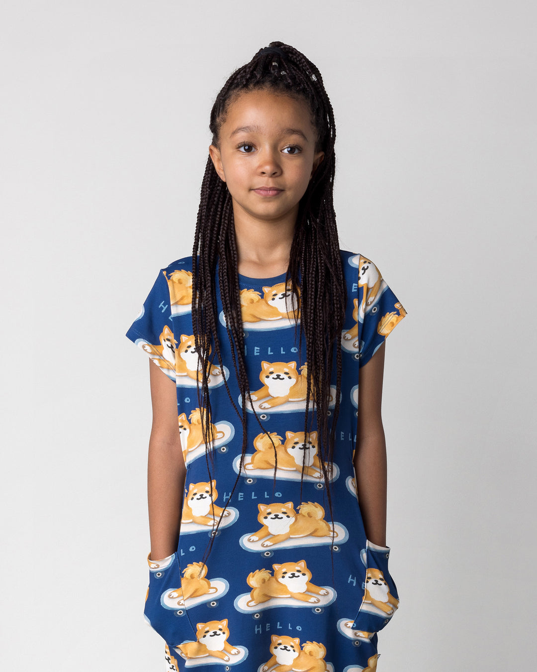 Close up of the Skate Puppy Dress in midnight on a kid, front view