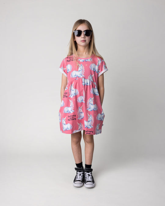 Kid wearing the Daydreaming Unicorn Dress in candy, front view