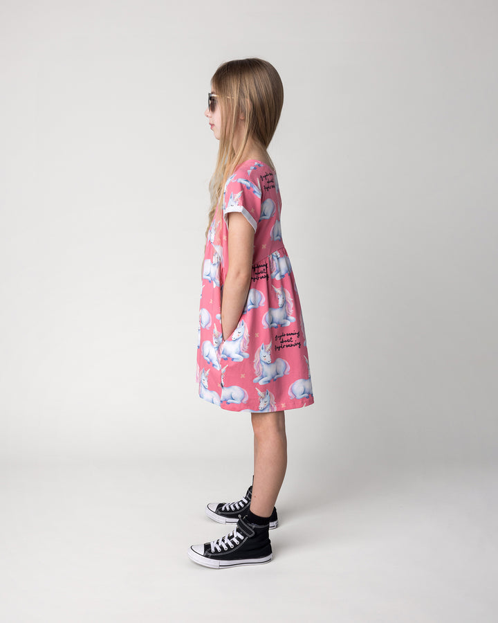 Kid wearing the Daydreaming Unicorn Dress in candy, side view