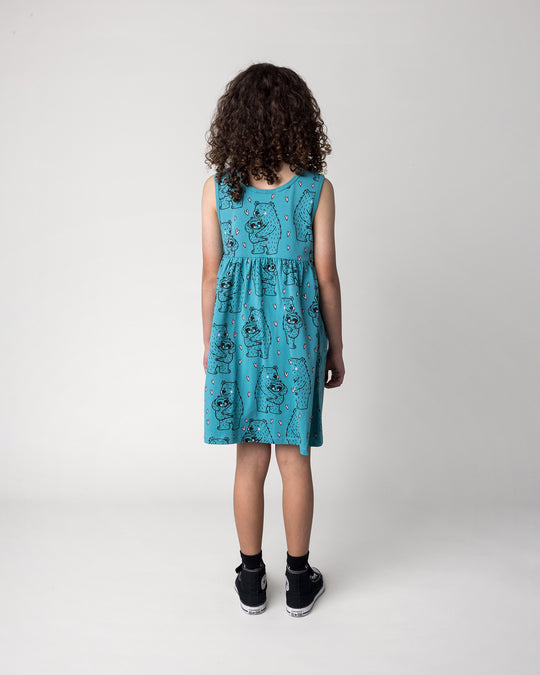 Kid wearing the Bear Hug Dress in emerald, back view