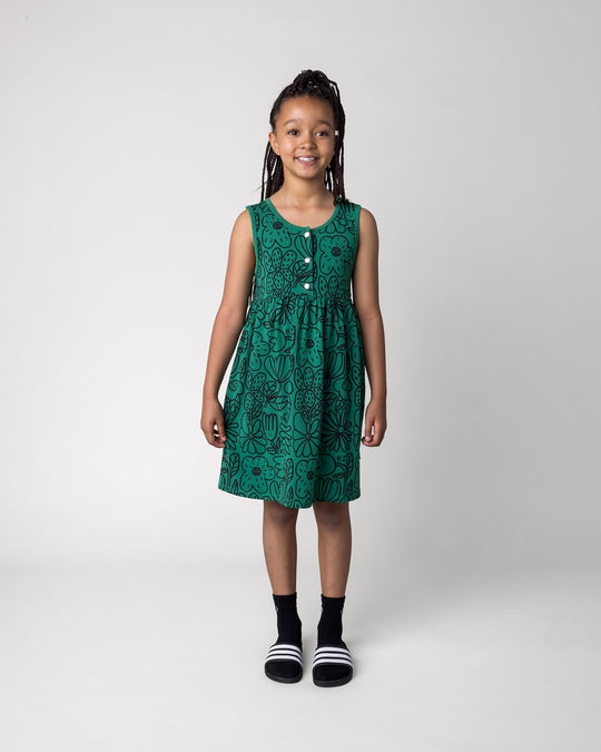 Kid wearing the Big Flowers Dress in kelly green, front view