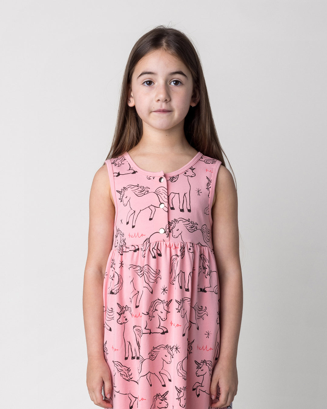Close up of the Hello Unicorns Dress in pink on a kid, front view