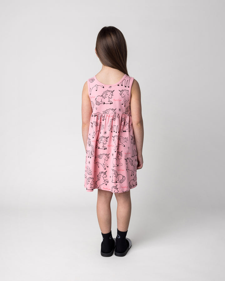 Kid wearing the Hello Unicorns Dress in pink, back view