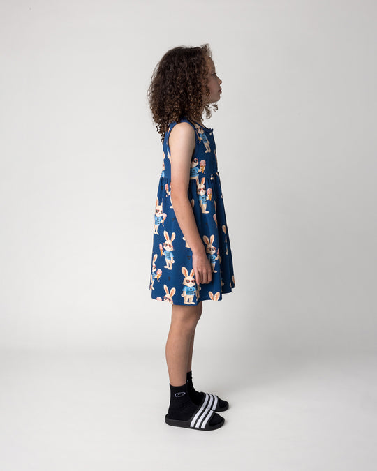 Kid wearing the Icecream Bunny Dress in blue, side view