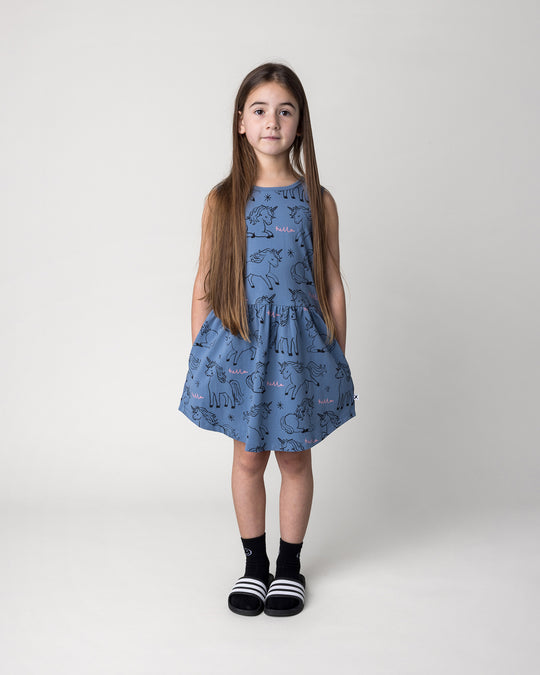 Kid wearing the Hello Unicorns Dress in mid blue, front view