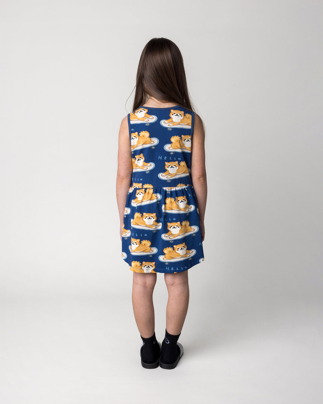 Kid wearing the Skate Puppy Dress in midnight, back view