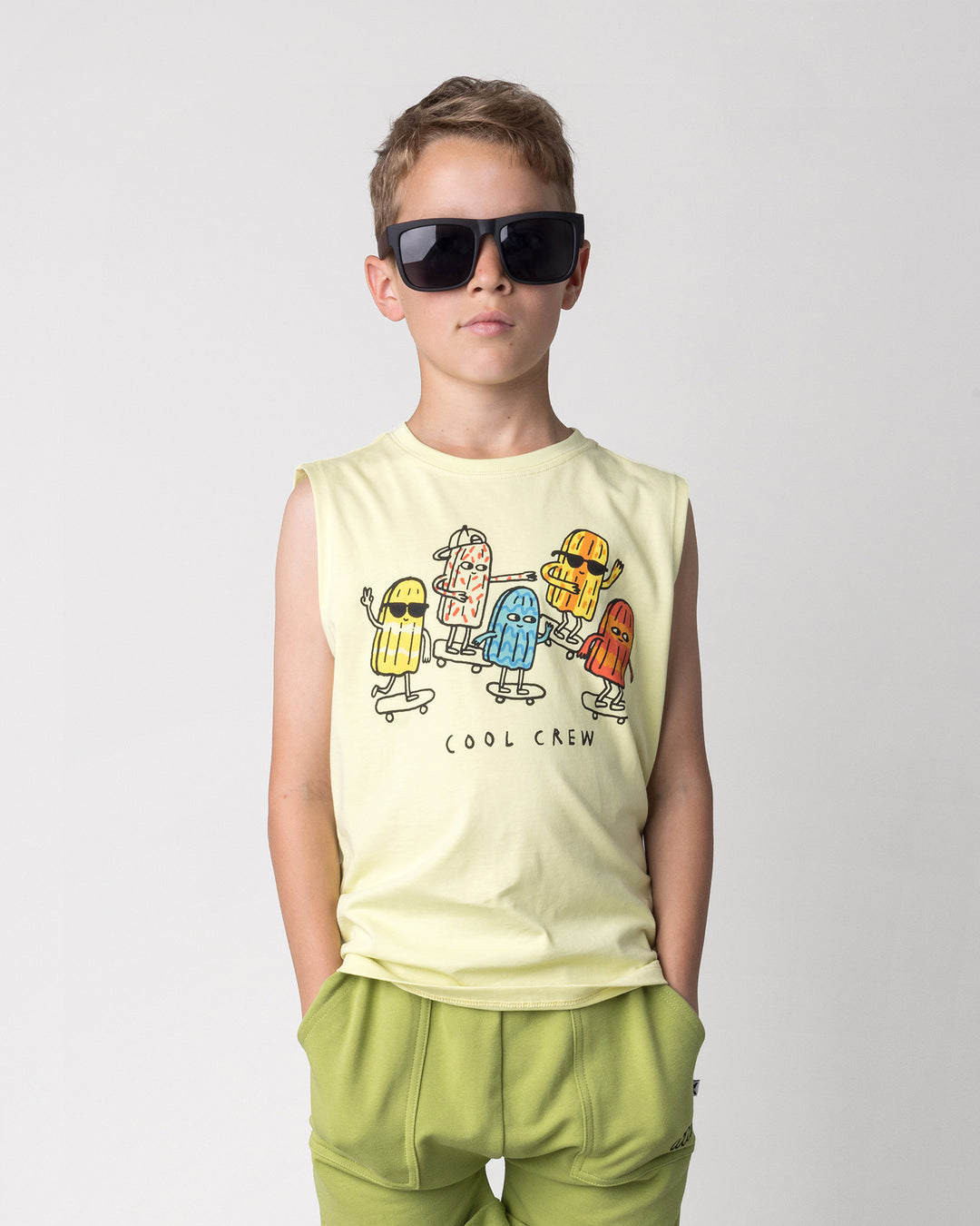Close up of the Cool Crew Sleeveless Tee in light zest on a kid, front view