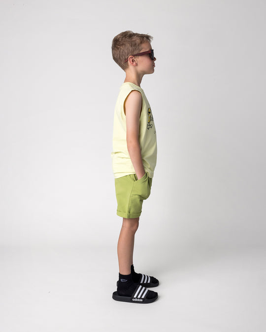 Kid wearing the Cool Crew Sleeveless Tee in light zest with the Roller Short in lime, side view