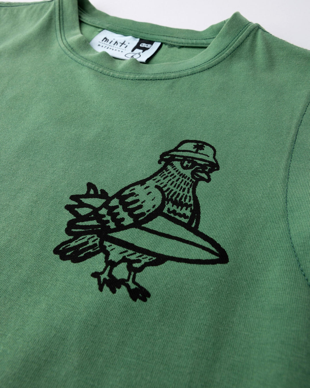 Close up of the Hi Pigeon Sleeveless Tee print in turf wash