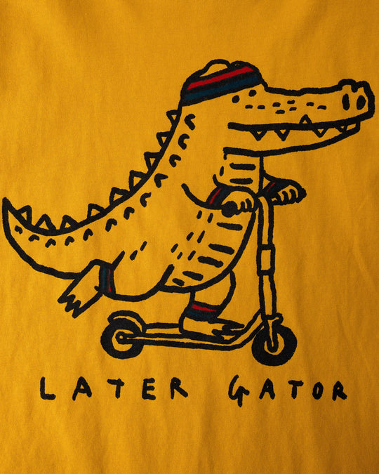Close up of the Later Gator Sleeveless Tee print in mustard
