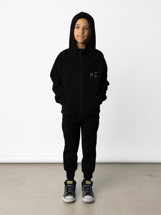 Minti kids clothing. Super cosy and soft Zip Up made in teddy with 2x2 rib cuffs and hem. Front pocket to keep hands warm. 70% Polyester // 30% Cotton.