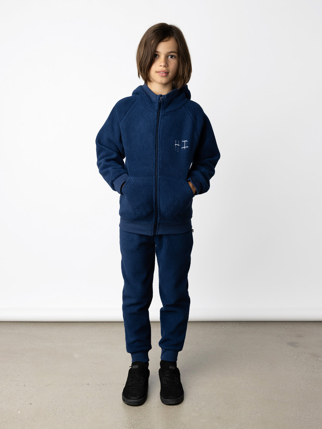 Minti kids clothing. Super cosy and soft Zip Up made in teddy with 2x2 rib cuffs and hem. Front pocket to keep hands warm. 70% Polyester // 30% Cotton.