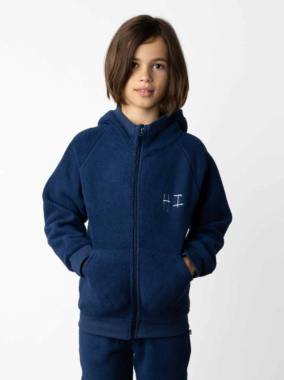 Minti kids clothing. Super cosy and soft Zip Up made in teddy with 2x2 rib cuffs and hem. Front pocket to keep hands warm. 70% Polyester // 30% Cotton.