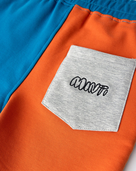 Close up detail of the Sliced Short in teal, orange and grey marle