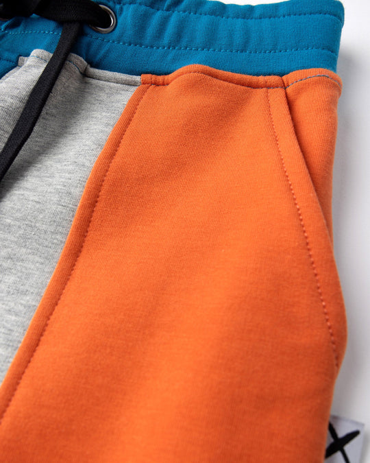 Close up detail of the Sliced Short in teal, orange and grey marle