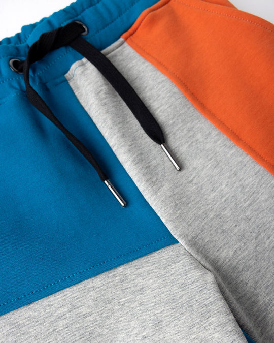 Close up detail of the Sliced Short in teal, orange and grey marle