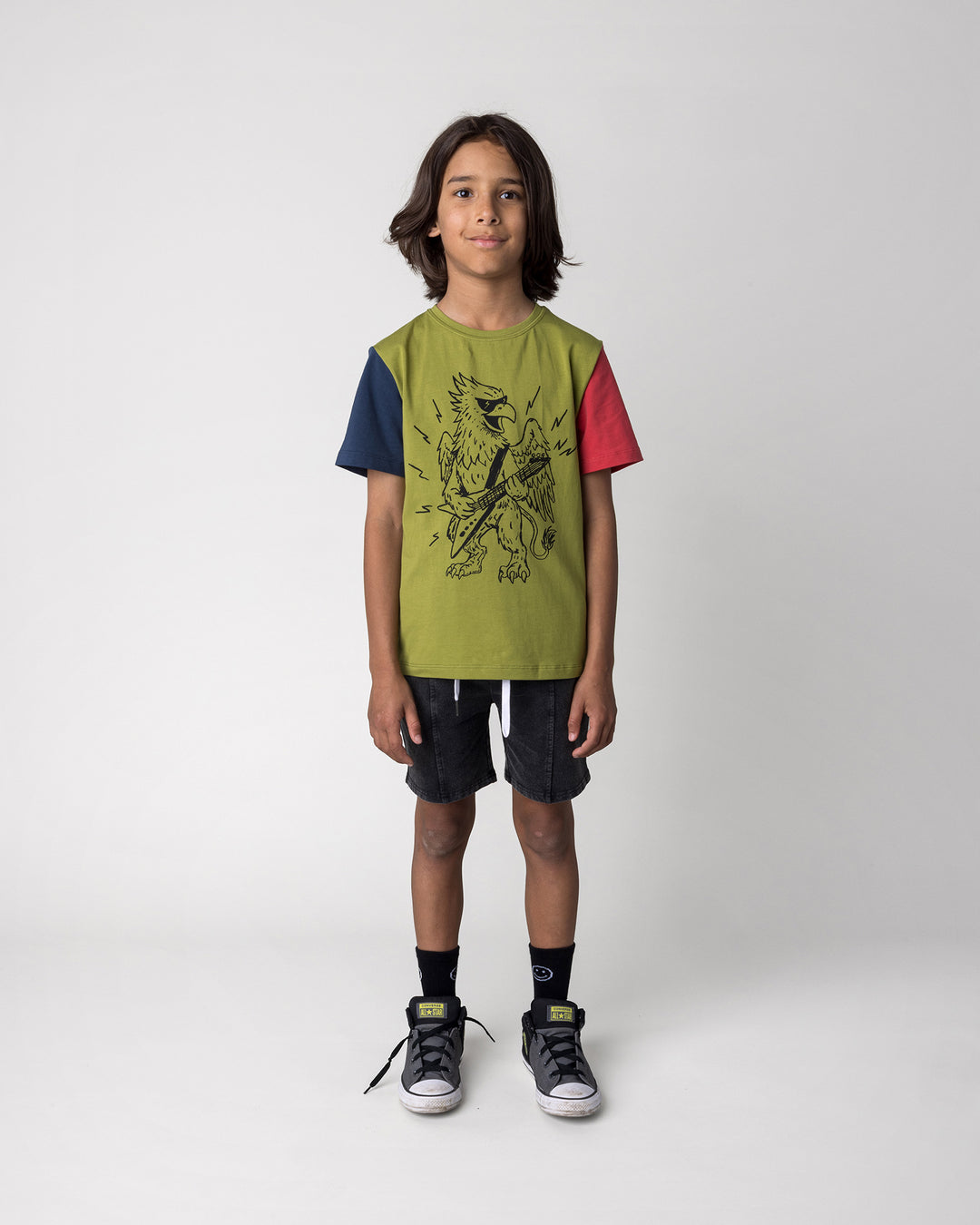 Kid wearing the Blasted Panel Short in black wash with the Rock Griffin Tee in olive, ink and melon, front view