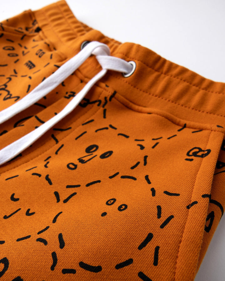 Close up detail of the Different Faces Short in burnt orange