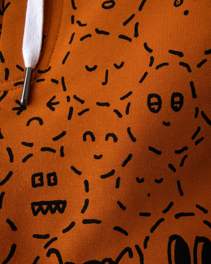 Close up of the Different Faces Short print in burnt orange